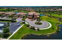 A beautiful home from an aerial view, situated on a corner lot near a pond and lush green landscaping at 6406 Grand Estuary Trl # 102, Bradenton, FL 34212