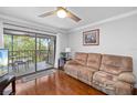 Comfortable living room with wood floors, slider to balcony, and stylish decor create a warm ambiance at 7203 Curtiss Ave # 3D, Sarasota, FL 34231