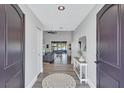 Bright foyer with wood flooring, opening up to a spacious living area and scenic views of the waterfront at 75 Inlets Blvd # 75, Nokomis, FL 34275