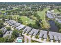 Aerial view of the community with a golf course, serene ponds, and well-maintained landscaping at 7724 Palm Aire Ln, Sarasota, FL 34243