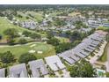 Scenic aerial view showcases community's lush golf course, waterways, and tennis courts at 7724 Palm Aire Ln, Sarasota, FL 34243