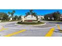Willowbrook community entrance with brick roundabout and lush landscaping at 9008 White Sage Loop # 3605, Lakewood Ranch, FL 34202