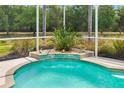 Inviting pool with a tranquil waterfall feature for a relaxing backyard retreat at 9101 Yarberry St, Sarasota, FL 34240