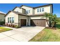 Home with two car garage, landscaped yard, stone accents and palm trees at 13116 Bliss Loop, Bradenton, FL 34211