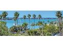 Scenic water view showcasing palm trees, boats, and the coastline in a serene setting at 101 S Gulfstream Ave # 5J, Sarasota, FL 34236