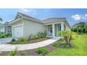 Charming single-Gathering home boasting a well-manicured lawn and a cozy front porch perfect for enjoying the outdoors at 10105 Canaveral Cir, Sarasota, FL 34241