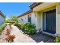 Home features a welcoming entrance with a walkway, lush landscaping and classic architectural details at 10205 Saint Francis Ter, Palmetto, FL 34221