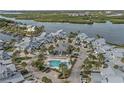 Beautiful aerial view of the waterfront community with a swimming pool and lush tropical landscaping at 1223 Siesta Bayside Dr # 1223, Sarasota, FL 34242