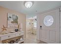 Inviting entryway featuring a decorative door with natural light and stylish decor leading into the dining room at 1223 Siesta Bayside Dr # 1223, Sarasota, FL 34242