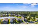 Residential community with homes surrounding a pond, showcasing a serene neighborhood at 12565 Ryegrass Loop, Parrish, FL 34219