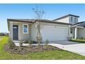 Charming single-story home featuring a large white garage door and neutral colored exterior paint at 14061 Crutchfield Ct, Parrish, FL 34219