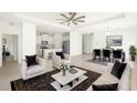 Bright, open-concept living room flows into the kitchen and dining area, perfect for entertaining at 16849 Castoro Dr, Port Charlotte, FL 33953