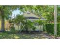 Charming home featuring a well-kept lawn, lush trees, and classic architecture, offering serene suburban living at 1742 9Th St, Sarasota, FL 34236