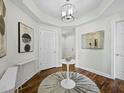 Elegant condo foyer with hardwood floors, decorative lighting, and sophisticated wall art at 1771 Ringling Blvd # 1104, Sarasota, FL 34236