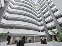 Expansive condo lobby featuring a soaring atrium and elegant decor with indoor plants at 1771 Ringling Blvd # 1104, Sarasota, FL 34236