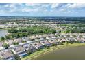 Scenic aerial view of community homes, serene ponds and solar panels in a desirable neighborhood at 18045 Polo Trail St, Bradenton, FL 34211