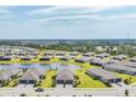 Expansive aerial view of a residential community featuring a central lake and well-maintained landscaping at 2072 Mackerel St, Port Charlotte, FL 33953