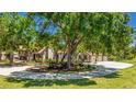 Beautifully landscaped home featuring a circular driveway and lush greenery, offering a serene and private setting at 222 High Point Dr, Venice, FL 34292