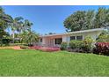 Single story home featuring beautiful landscaping and a red brick walkway at 2425 Calamonga Ln, Sarasota, FL 34239