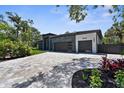 Beautifully landscaped modern home featuring a spacious driveway and a sleek two-car garage at 2632 Hawthorne St, Sarasota, FL 34239