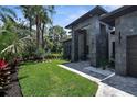 Contemporary home with a well-manicured lawn, modern design elements, and a paver walkway at 2632 Hawthorne St, Sarasota, FL 34239