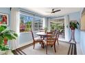Bright dining area with a charming table set, large windows, and a view to the outside screened patio at 3036 Rose St, Sarasota, FL 34239