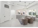 Bright living room featuring neutral decor, a modern chandelier, and views of the outdoor area at 3415 162Nd E Ave, Parrish, FL 34219