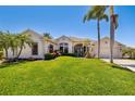 Beautiful single-story home with lush lawn and manicured tropical landscaping at 356 Blackbird Ct, Bradenton, FL 34212