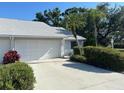 A single Gathering home showcasing the driveway leading to the attached garage at 3602 Bonaventure Ct, Sarasota, FL 34243