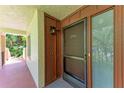 Close up of unit entrance with decorative trim, door, and an outdoor light fixture at 3803 Sun Eagle Ln # 203, Bradenton, FL 34210