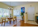 Bright dining room with a modern glass table, complemented by natural light and stylish decor at 3909 45Th W Ter # 102, Bradenton, FL 34210