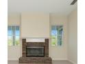 Living room featuring a brick fireplace and mantle with bright windows at 4092 Green Tree Ave, Sarasota, FL 34233