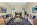 Inviting living room with fireplace, blue accent pillows, and decorative rug at 4092 Green Tree Ave, Sarasota, FL 34233