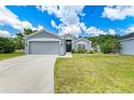 Attractive single-story home with a two-car garage, lush lawn, and inviting front entrance with decorative touches at 4513 Abacos Pl, Bradenton, FL 34203