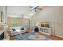Bright living room with vaulted ceilings, ceiling fan, arched windows and fireplace at 4691 Las Brisas Ln, Sarasota, FL 34238