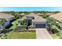Stunning single-story home with a tile roof, manicured lawn, and a two-car garage at 4908 Tivoli Run, Bradenton, FL 34211