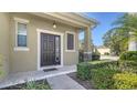 Close-up of the front door and entryway with a covered porch and stone accents at 5403 Mang Pl, Sarasota, FL 34238
