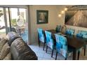Bright dining area with unique pendant lighting and seating for six at 6157 E Midnight Pass Rd # B51, Sarasota, FL 34242