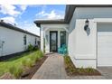 Inviting front porch with a brick pathway leading to the entrance of this beautiful property at 6248 Fish Eagle Ct, Nokomis, FL 34275