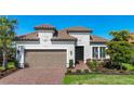 Lovely single-Gathering home featuring a tile roof, attached garage, landscaped front yard, and a welcoming entryway at 6290 Mesa Gln, Bradenton, FL 34203
