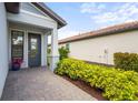 Inviting front entrance with manicured landscaping at 6295 Crested Eagle Ln, Nokomis, FL 34275