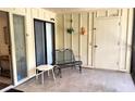 Enclosed patio area featuring tile flooring, sliding door, a bench, and a small table at 6462 Wild Oak Bay Blvd # 245, Bradenton, FL 34210