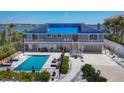 Beautiful two-story home with a pool, lounge chairs, and a picturesque waterfront setting at 7985 Manasota Key Rd, Englewood, FL 34223