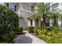Charming home entrance with a brick walkway, lush landscaping, and a welcoming front door at 8045 Tybee Ct # 8045, University Park, FL 34201