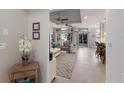 Bright living room with tile flooring, ceiling fans, and sliding glass doors leading to the outdoors at 8045 Tybee Ct # 8045, University Park, FL 34201