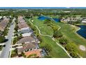 Community aerial showcasing golf course, water features and residences at 8771 52Nd E Ave, Bradenton, FL 34211