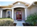 Inviting front entryway with elegant double doors, decorative columns, and lush landscaping for curb appeal at 9112 63Rd E Ct, Parrish, FL 34219