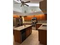 Bright kitchen with tile floor, an island, stainless steel appliances, granite countertops, and lots of storage space at 9112 63Rd E Ct, Parrish, FL 34219