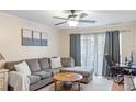 Comfortable living room space featuring a large window with curtains and a workstation at 3269 Beneva Rd # 102, Sarasota, FL 34232