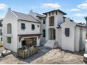 Exterior of modern two-story home featuring a light-colored facade, covered entry, and unfinished landscaping at 114 Fillmore Dr, Sarasota, FL 34236